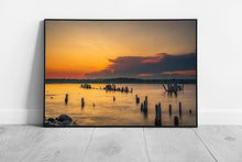 Load image into Gallery viewer, Vibrant Seaside Sunset: Framed Coastal Artwork with Weathered Wooden Ruins Above Serene Seashore - Print Store
